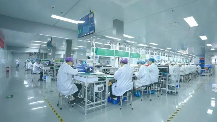 Workers produce hearing AIDS