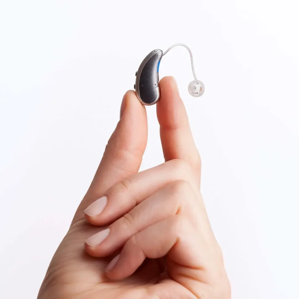 Holding a hearing aid in hand