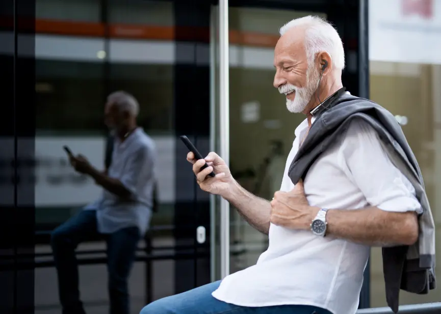 Playing with a mobile phone while wearing a neckband hearing aid